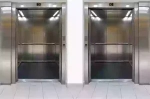 Two passenger elevators open side by side