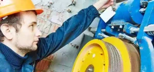 Engineers performing safety inspections on the elevator braking system and speed limiter.