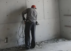 The picture shows a waterproof engineer cleaning the elevator shaft
