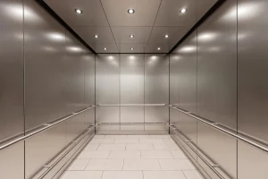 Interior of a service elevator designed for heavy-duty use in a hospital, with ample space for beds and medical equipment
