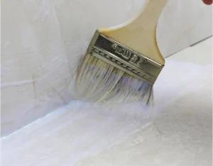 The picture shows waterproof sealant being applied to the joints of the elevator.