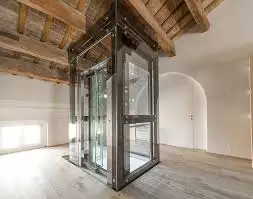 The glass residential elevator that reaches the top floor shows its transparency