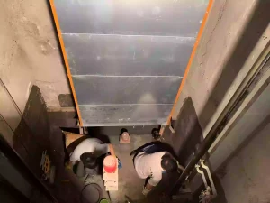 The picture shows a waterproof engineer working on the elevator pit waterproofing job site